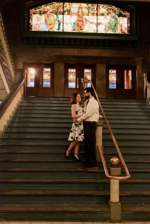 Couple on the stairs at Union Station in St. Louis, Missouri under stained glass window.