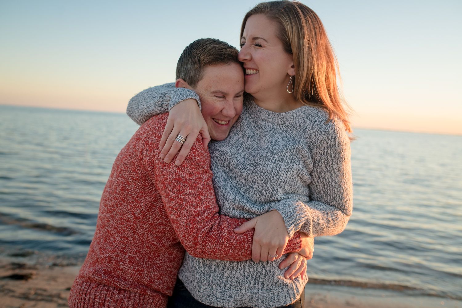Intimate couple's portrait session at sunset by the ocean.