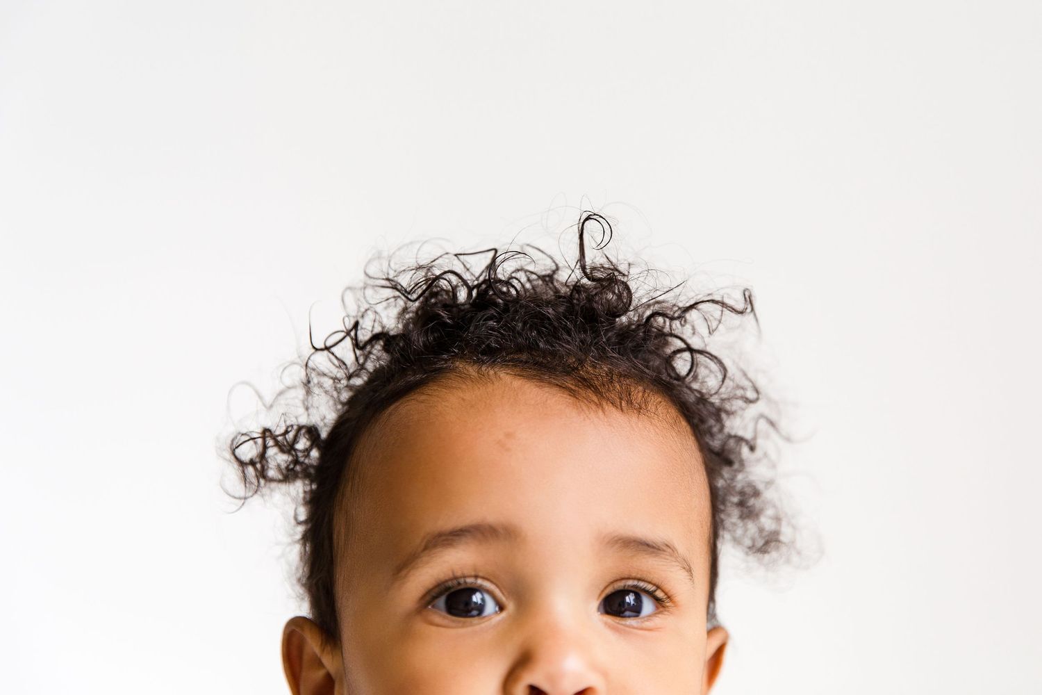 Close-up of dark curly baby hair