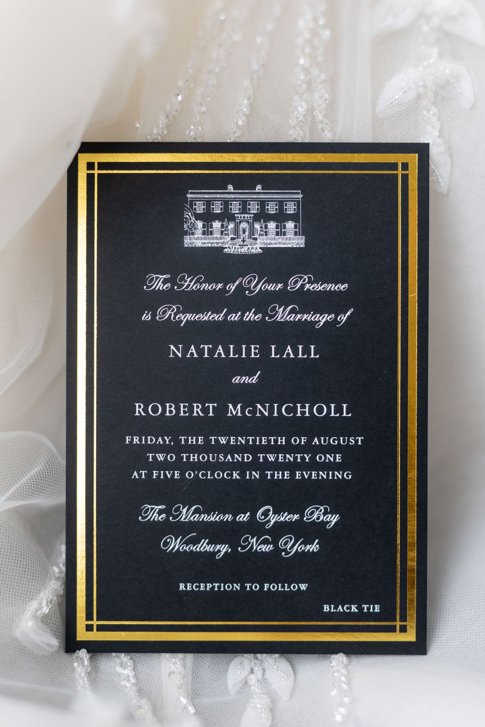 Elegant black and gold wedding invitation featuring mansion illustration.