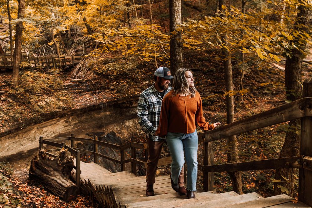 Man and woman walk away from Bridal Veil Falls in Pikes Peak State Park
