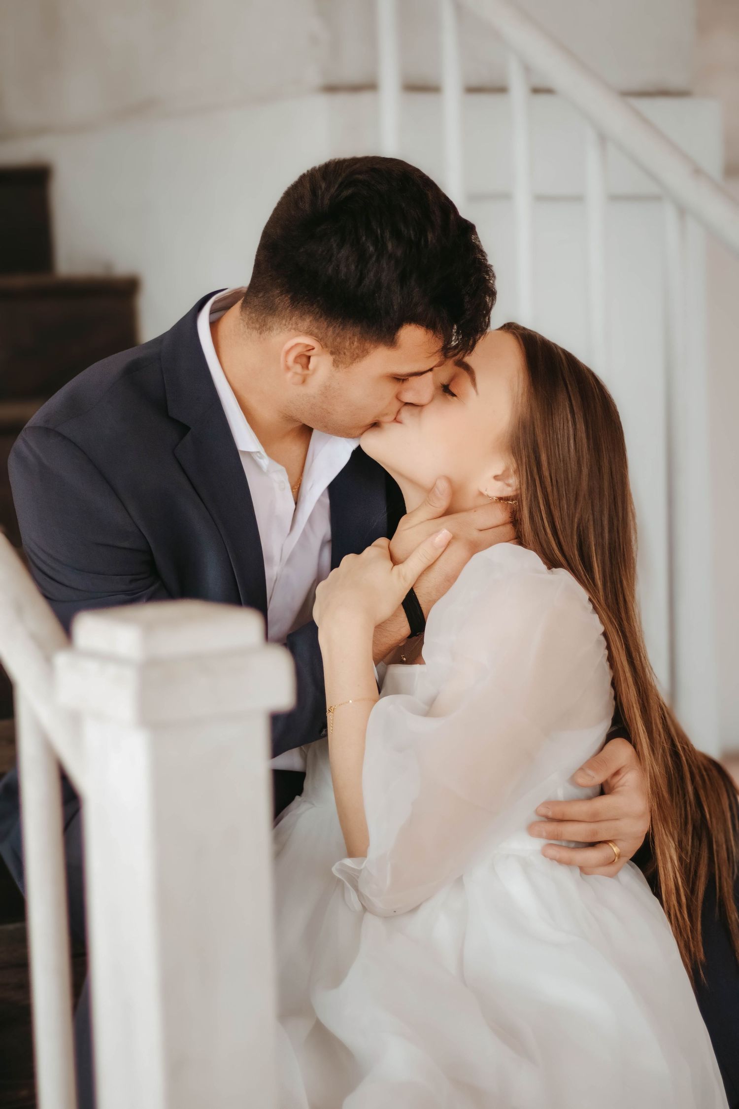 Couple embraces each other in kiss at downtown engagement photo session
