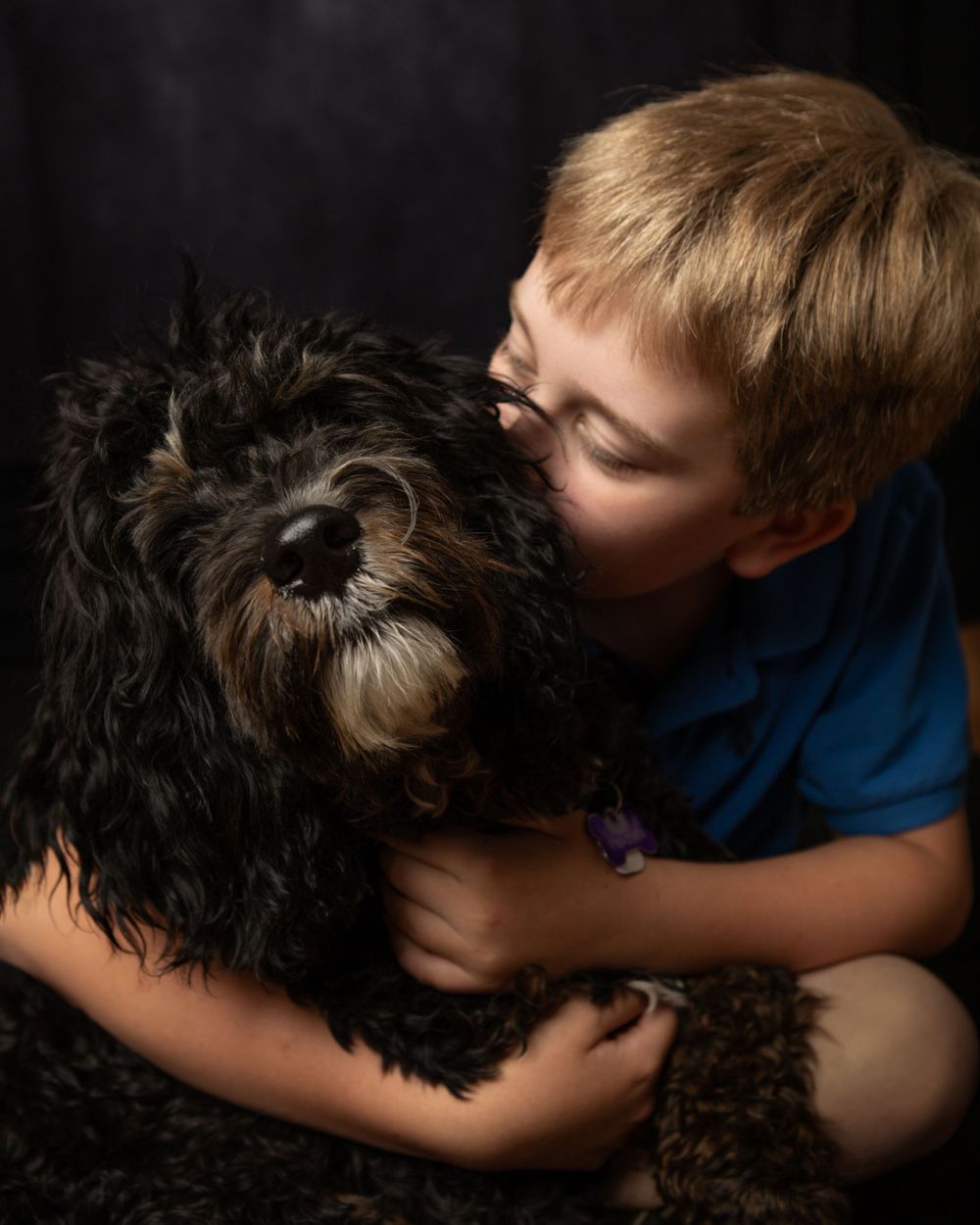 boy hugging his puppy