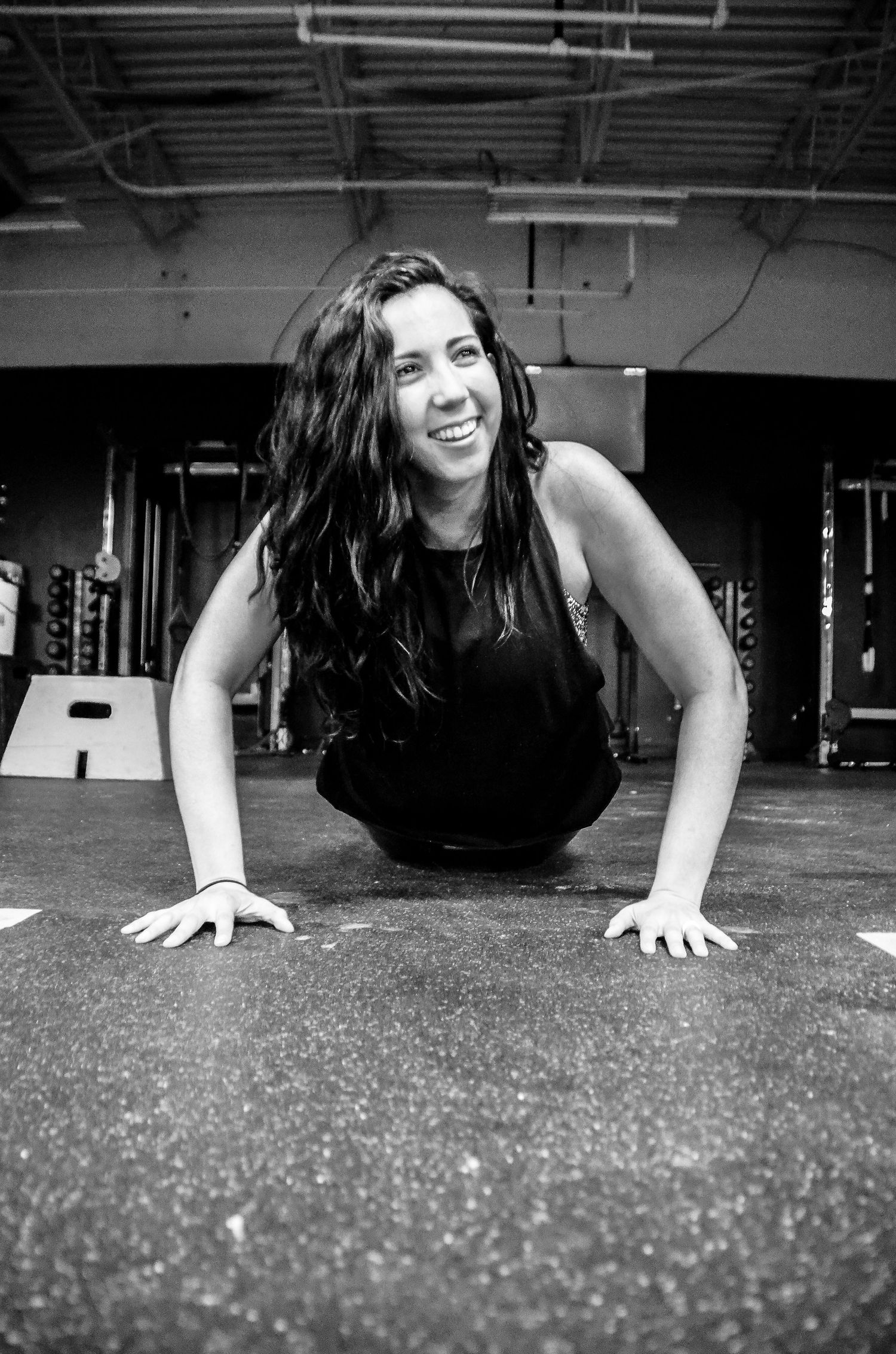 Black and white sequence showing someone doing push-ups on a gym floor.