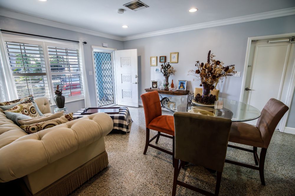 Open concept living space with comfortable seating and traditional dining area.