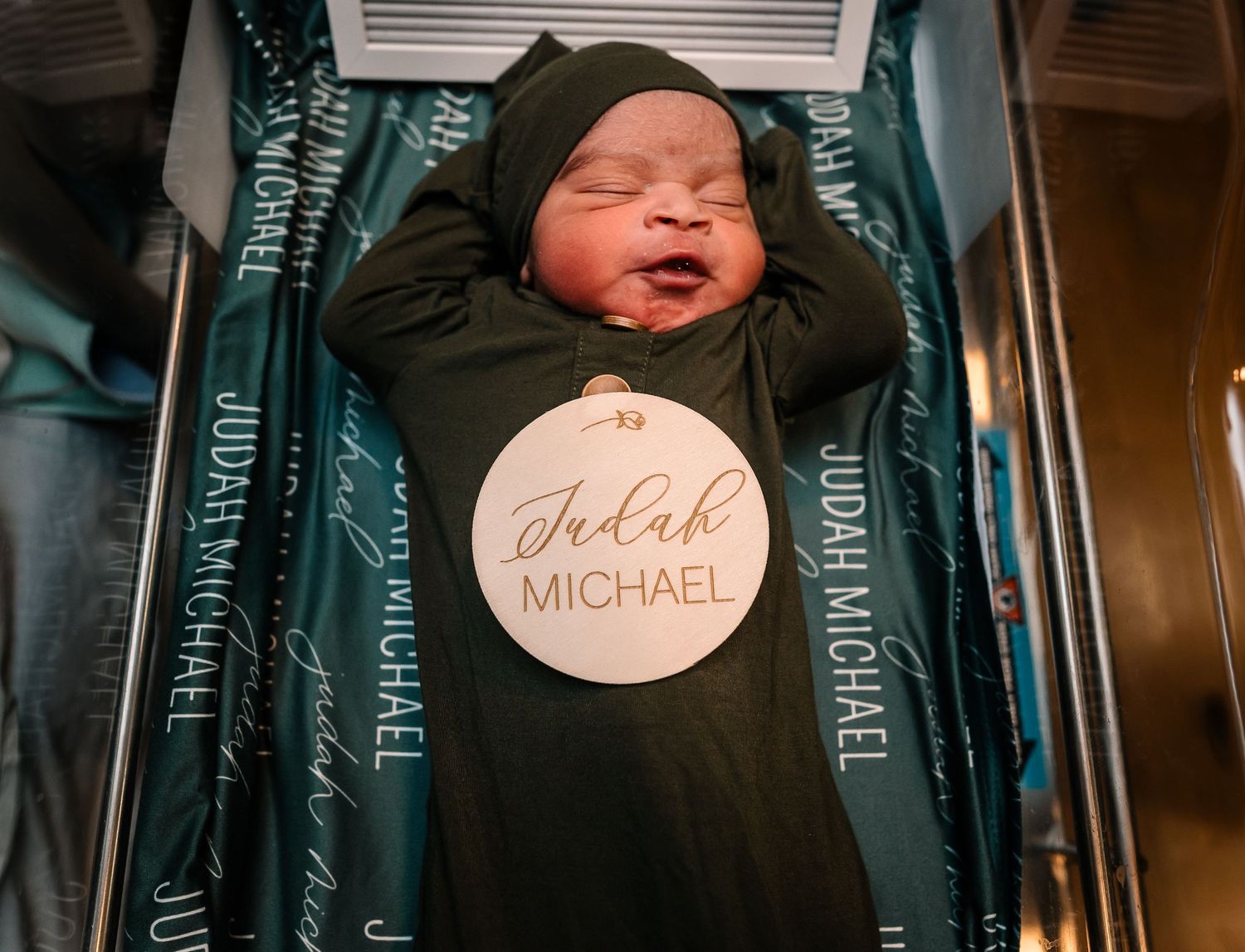 Baby In Hospital Bassinet With Name Plate On Chest, Newborn Pictures