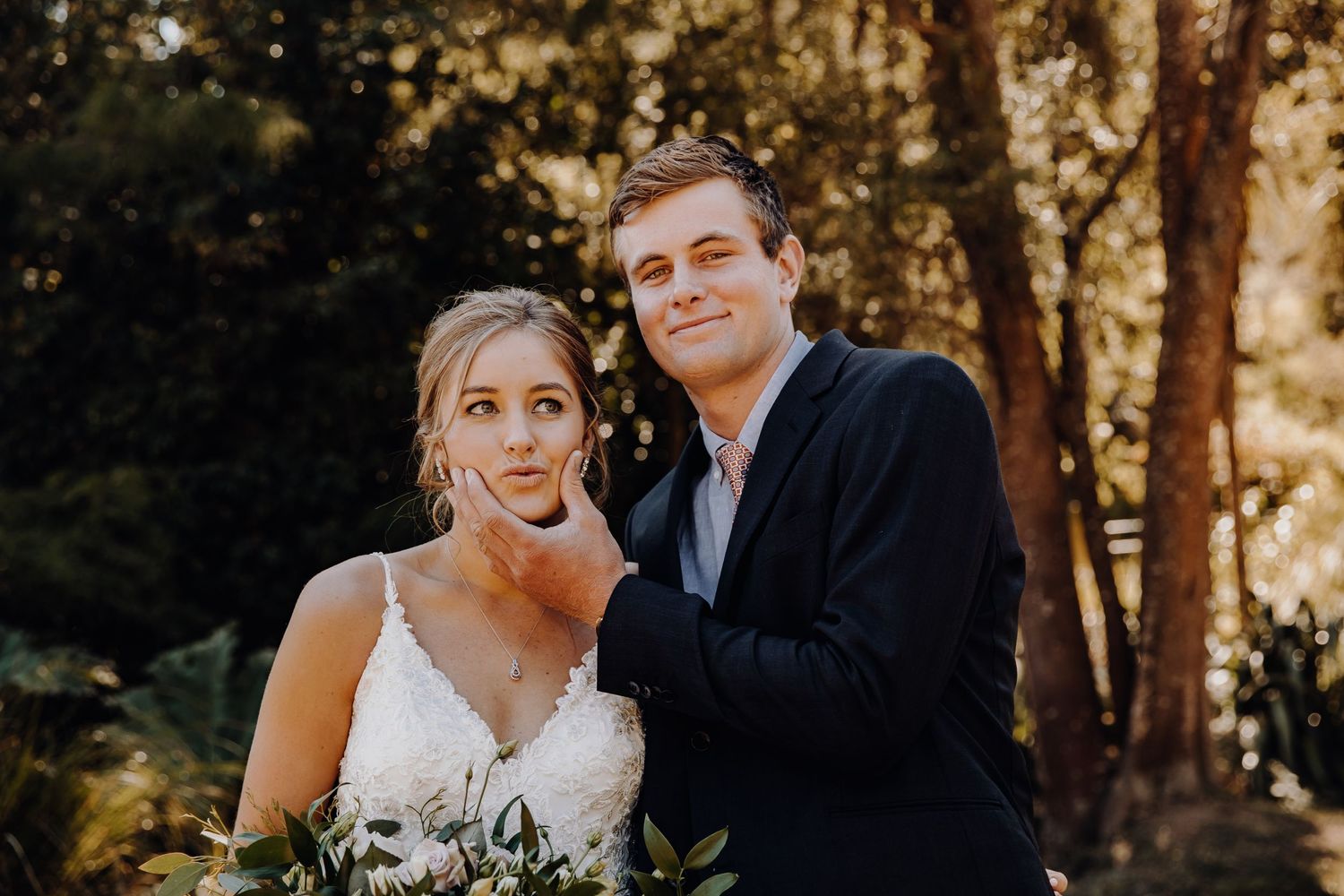 A bride and groom share an intimate moment in beautiful golden hour lighting.