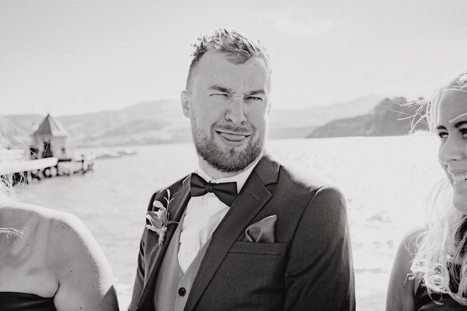 Close-up black and white portrait shots of elegantly dressed wedding party members.