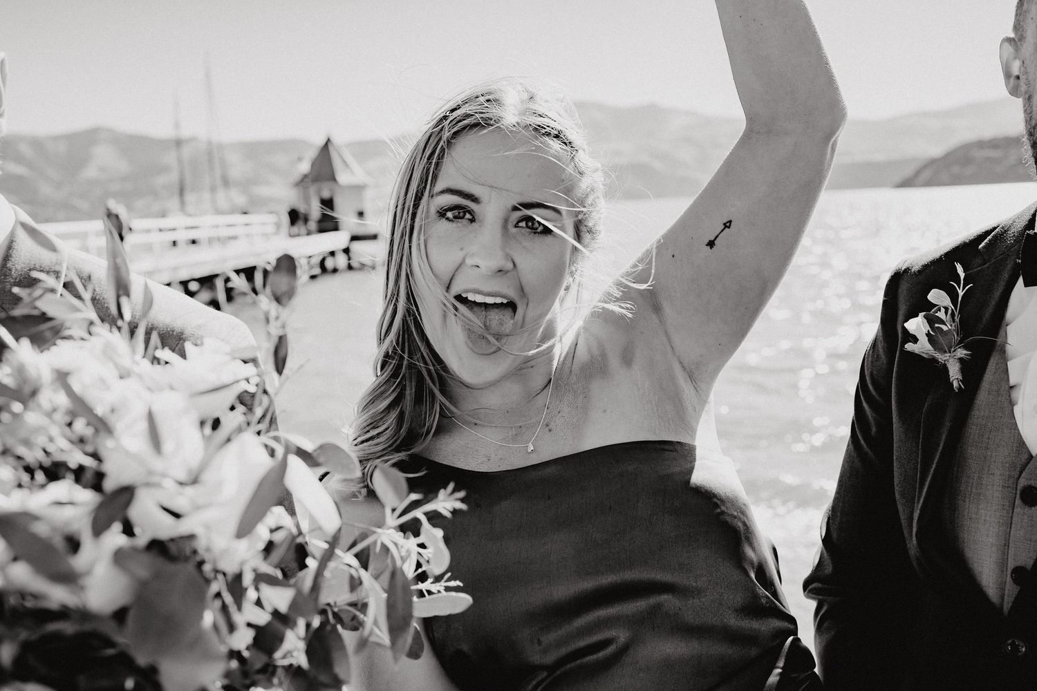 Candid black and white wedding photos capturing natural laughter and emotions outdoors.