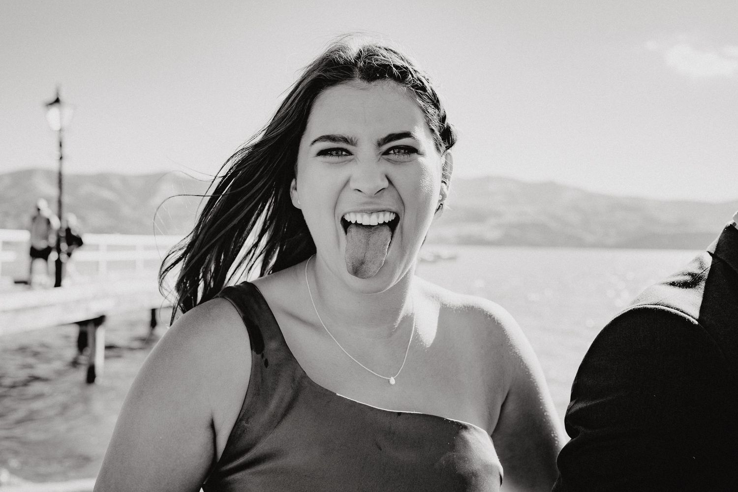 Black and white portraits capturing genuine emotions during outdoor wedding celebration.