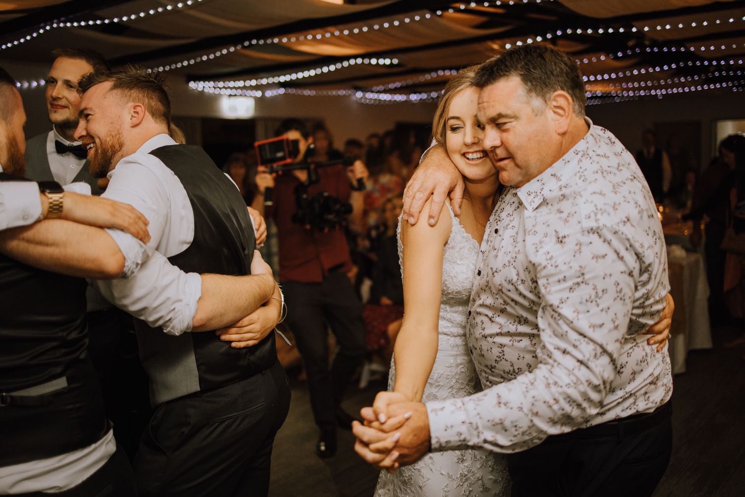 Wedding reception dance floor scene with guests enjoying lively celebration.