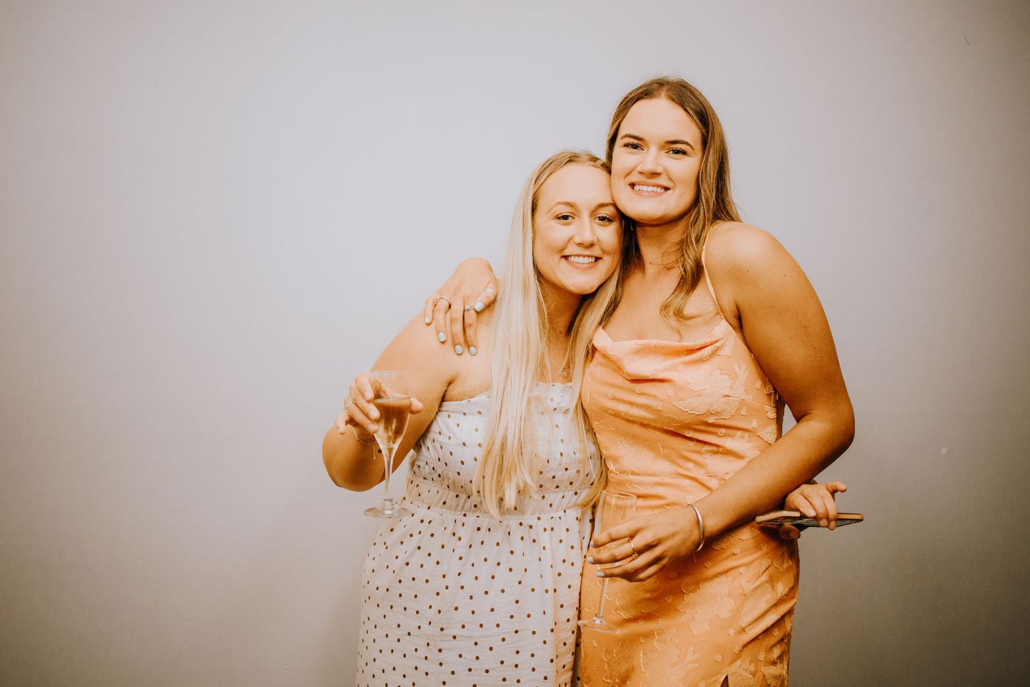 Two wedding guests pose together at reception celebration.