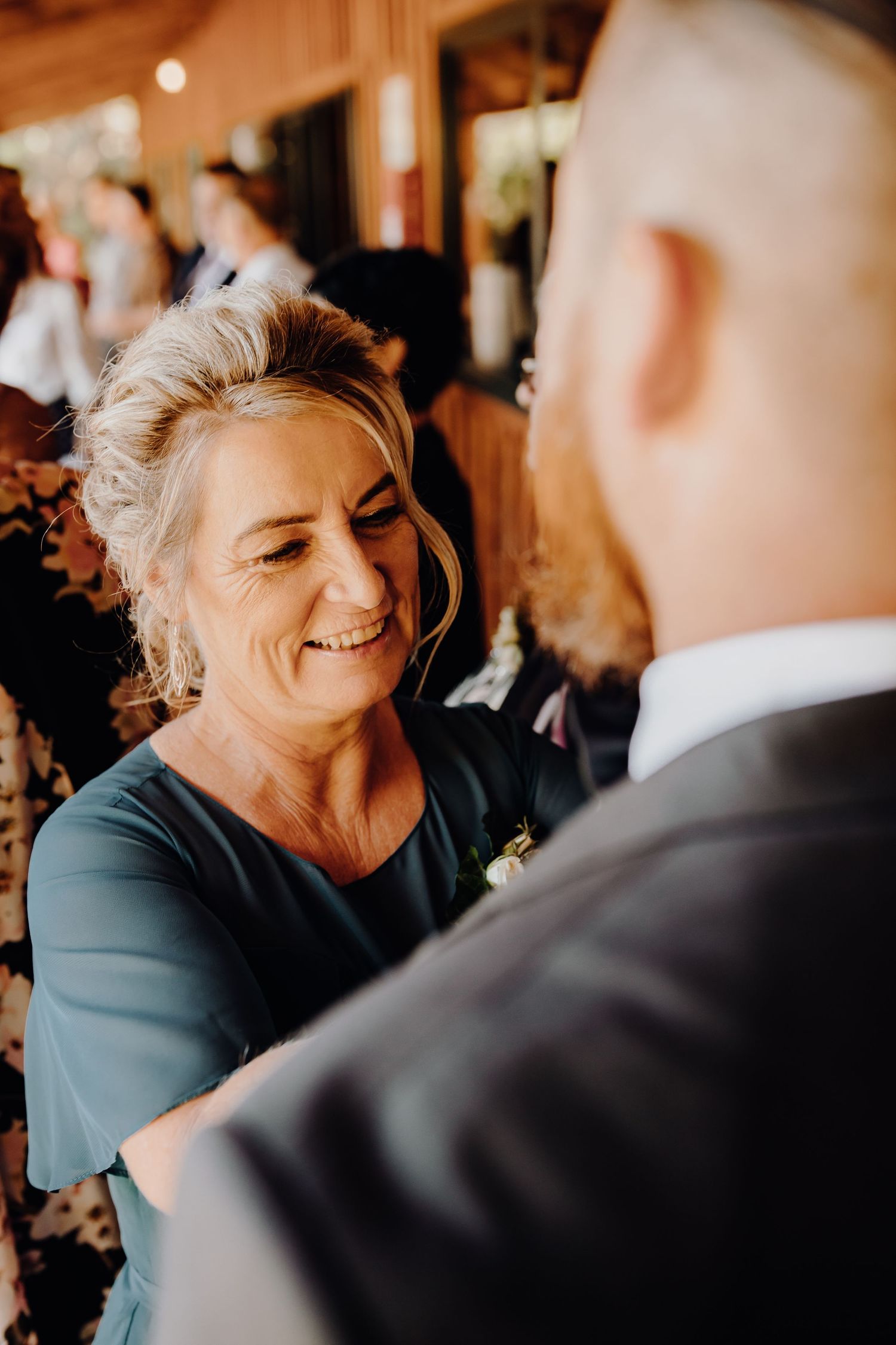 Heartwarming moment shared between two people during wedding celebration indoors.