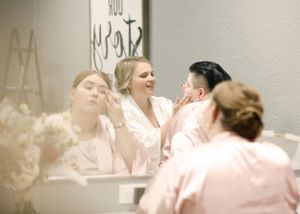 Bridesmaids in pink dresses sharing joyful moments at a wedding celebration.