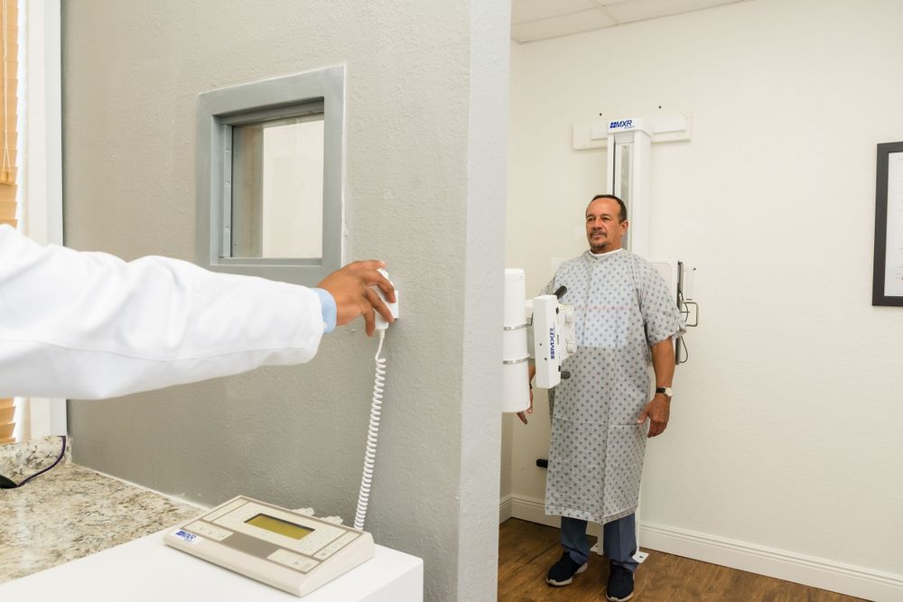 Height measurement being taken during medical examination in clinical room.