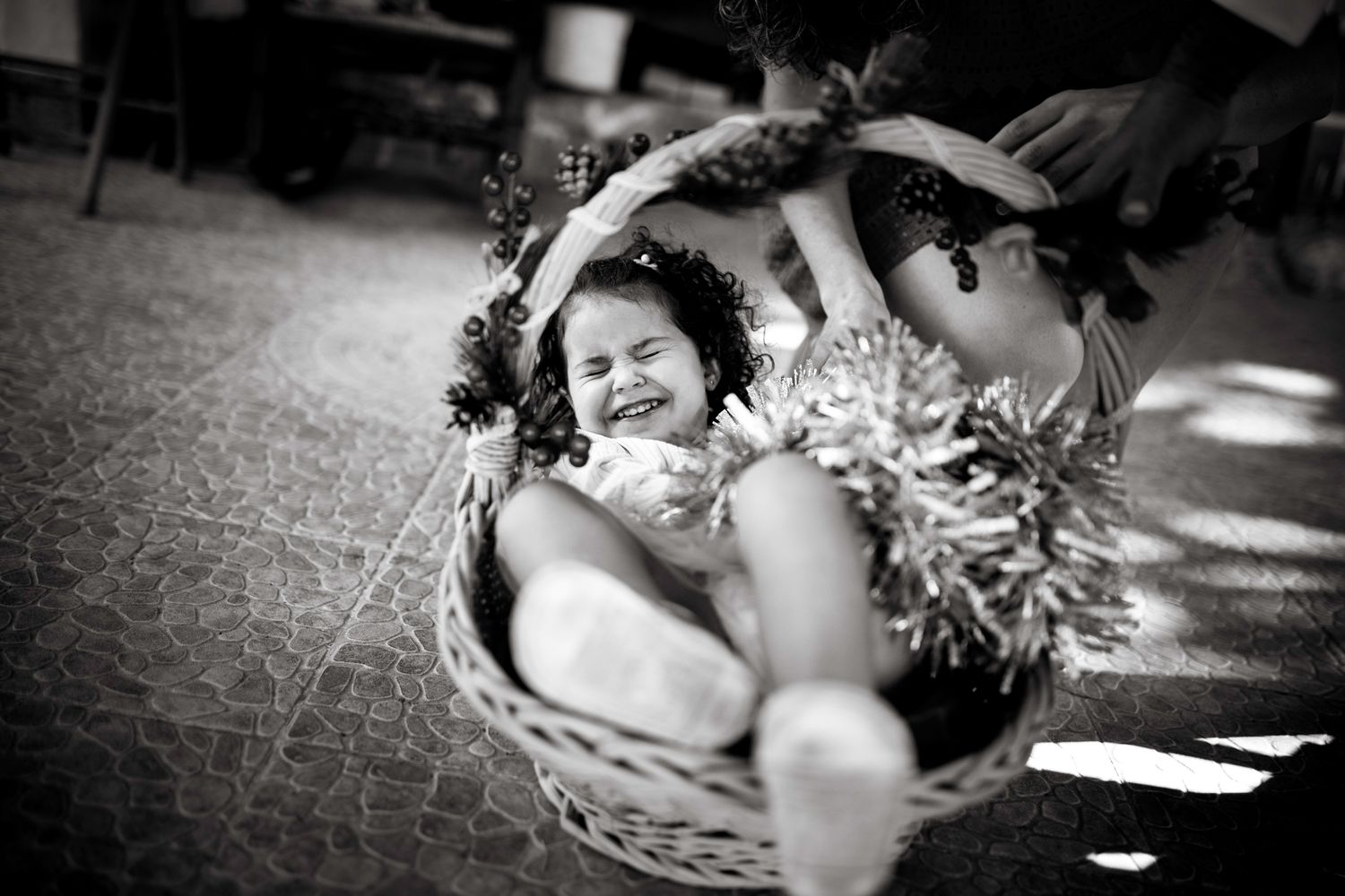 Girl having fun in a Christmas basket during Christmas family photo session