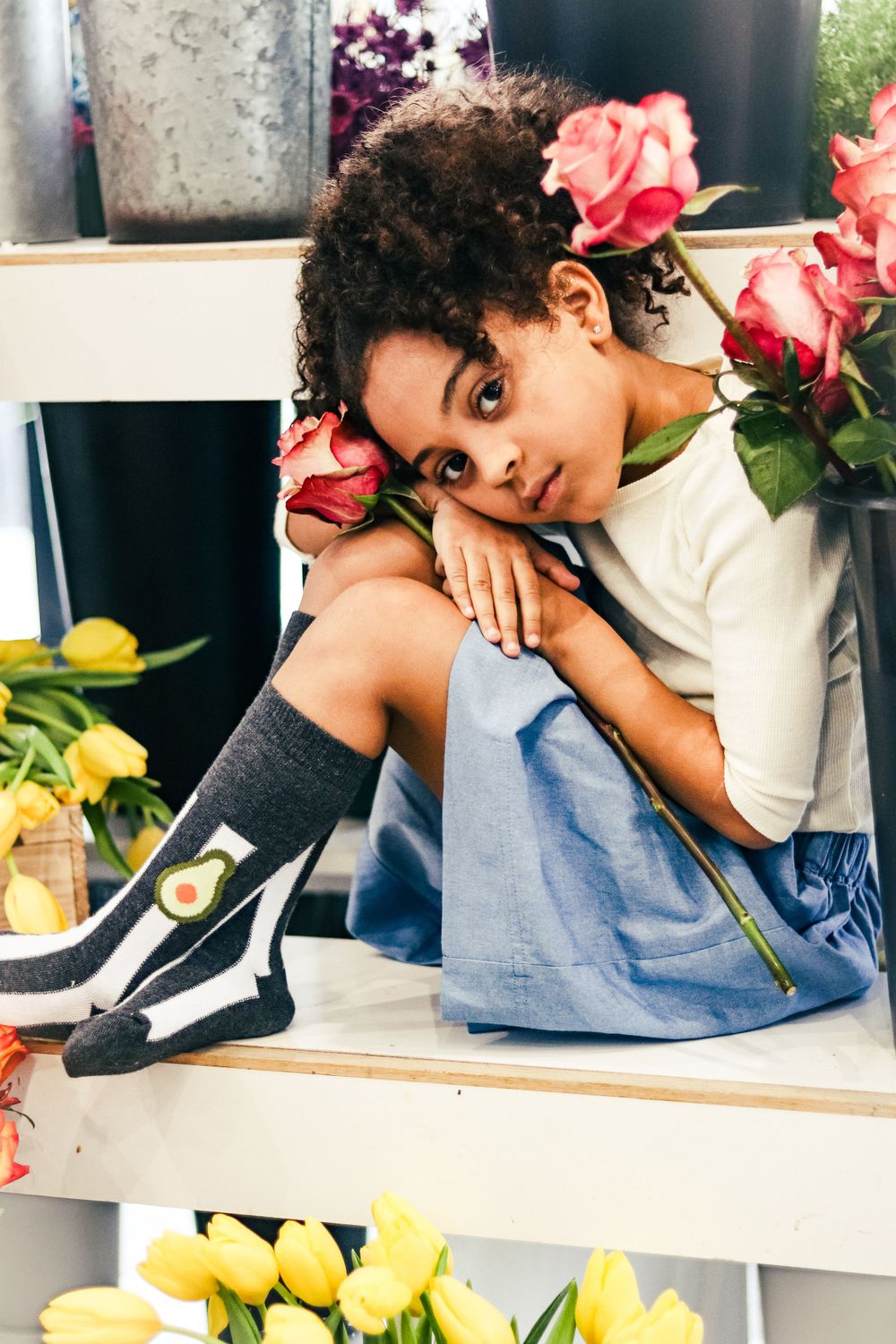 Cute black girl modeling for a clothing company in a lifestyle creative commercial photoshoot.