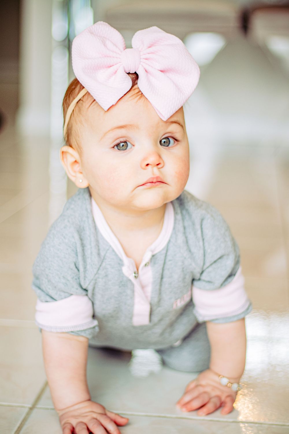 Baby girl modeling for a commercial brand photoshoot for an accessory brand.