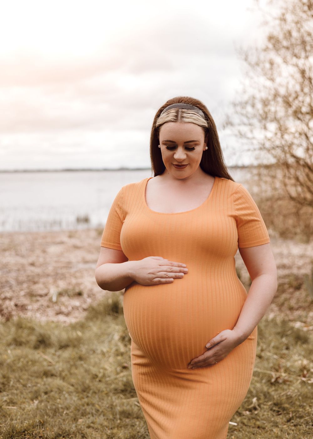 maternity photoshoot by lough ennell mum in orange dress