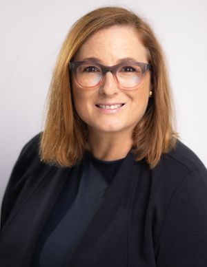 Business professional headshot with confident expression and studio lighting”