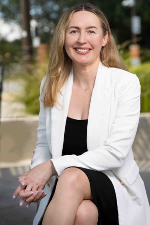 Business professional headshot with confident expression and studio lighting”