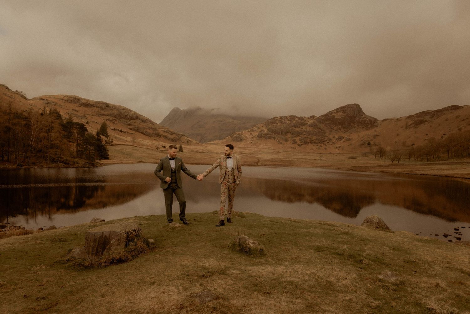 same sec couple elopement snowdonia two men holding hands floral wedding suit