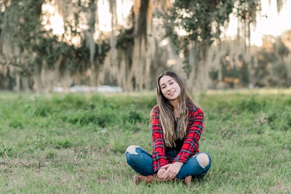teen sits on the grass at Circle B Bar Reserve Lakeland, Florida