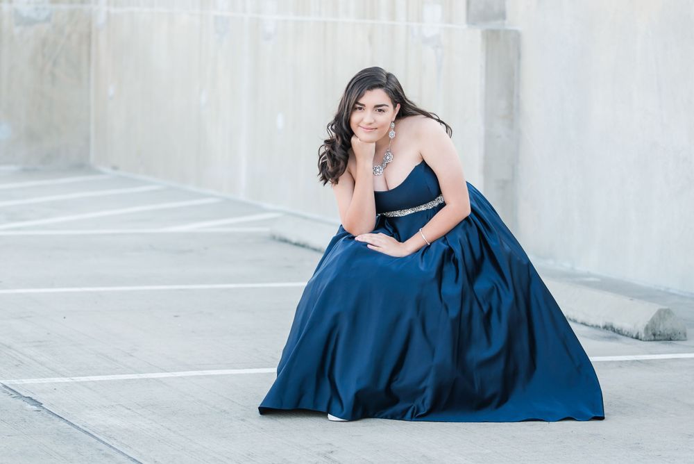 teen girl sits on rooftop of parking garage in Downtown Winter Haven Florida