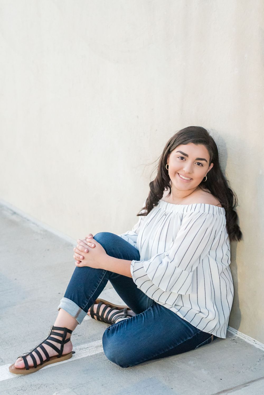 teen girl poses on top of parking garage Downtown Winter Haven Florida