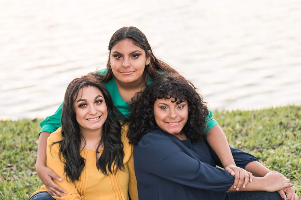 sisters pose together in front of Lake Mirror Downtown Lakeland Florida Hollis Gardens