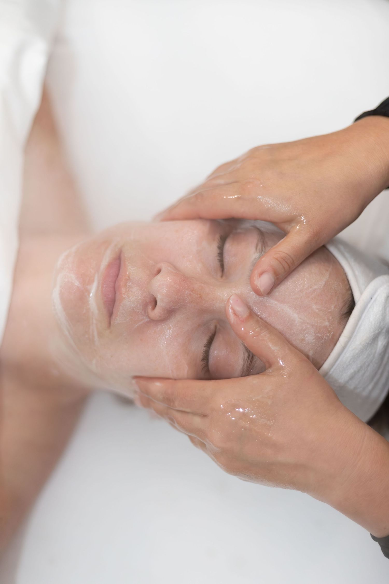 Facial massage being performed during luxury spa treatment.