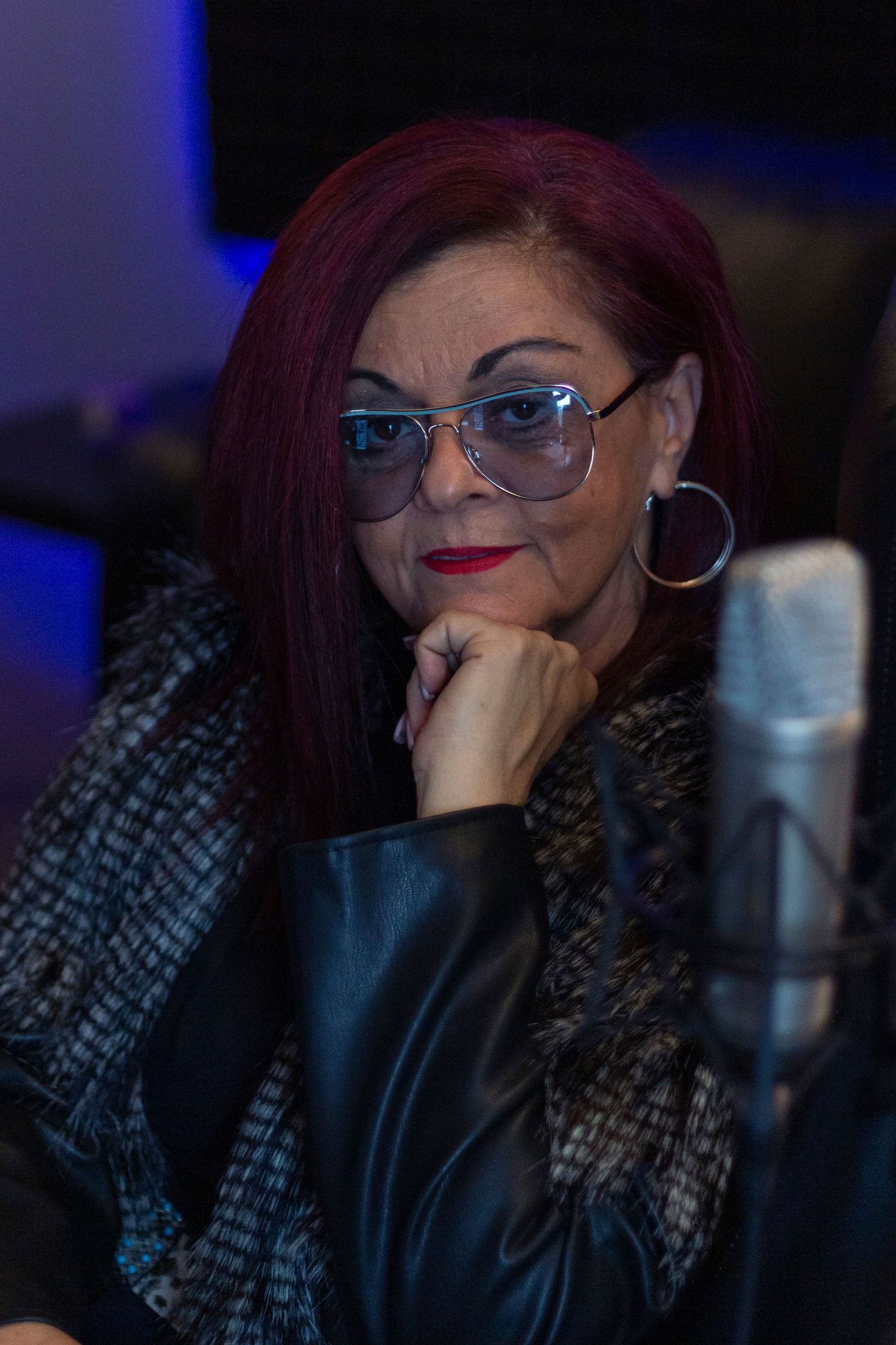 female leaning on her fist in a recording studio branding photography headshot