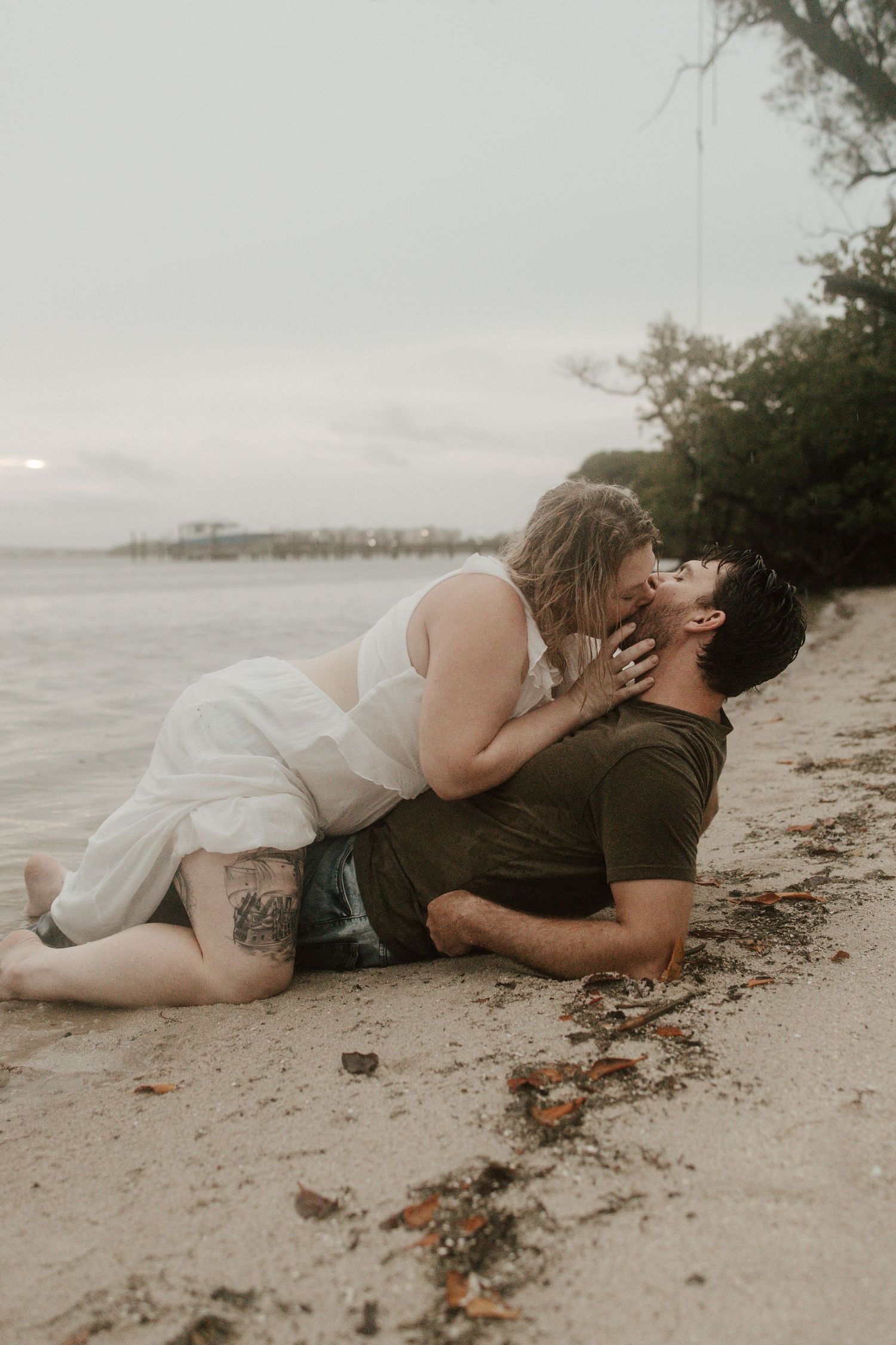 Couple kissing in the rain taken by South Florida Wedding Photographer Lemon and Honey Co.