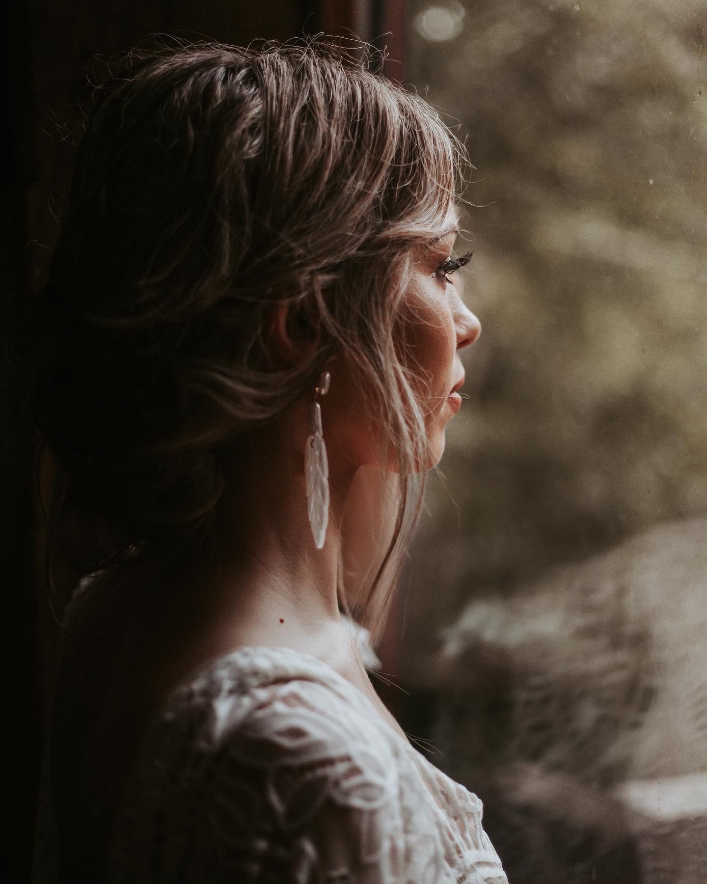 Bride looking out the window taken by South Florida Wedding Photographer Lemon and Honey Co.