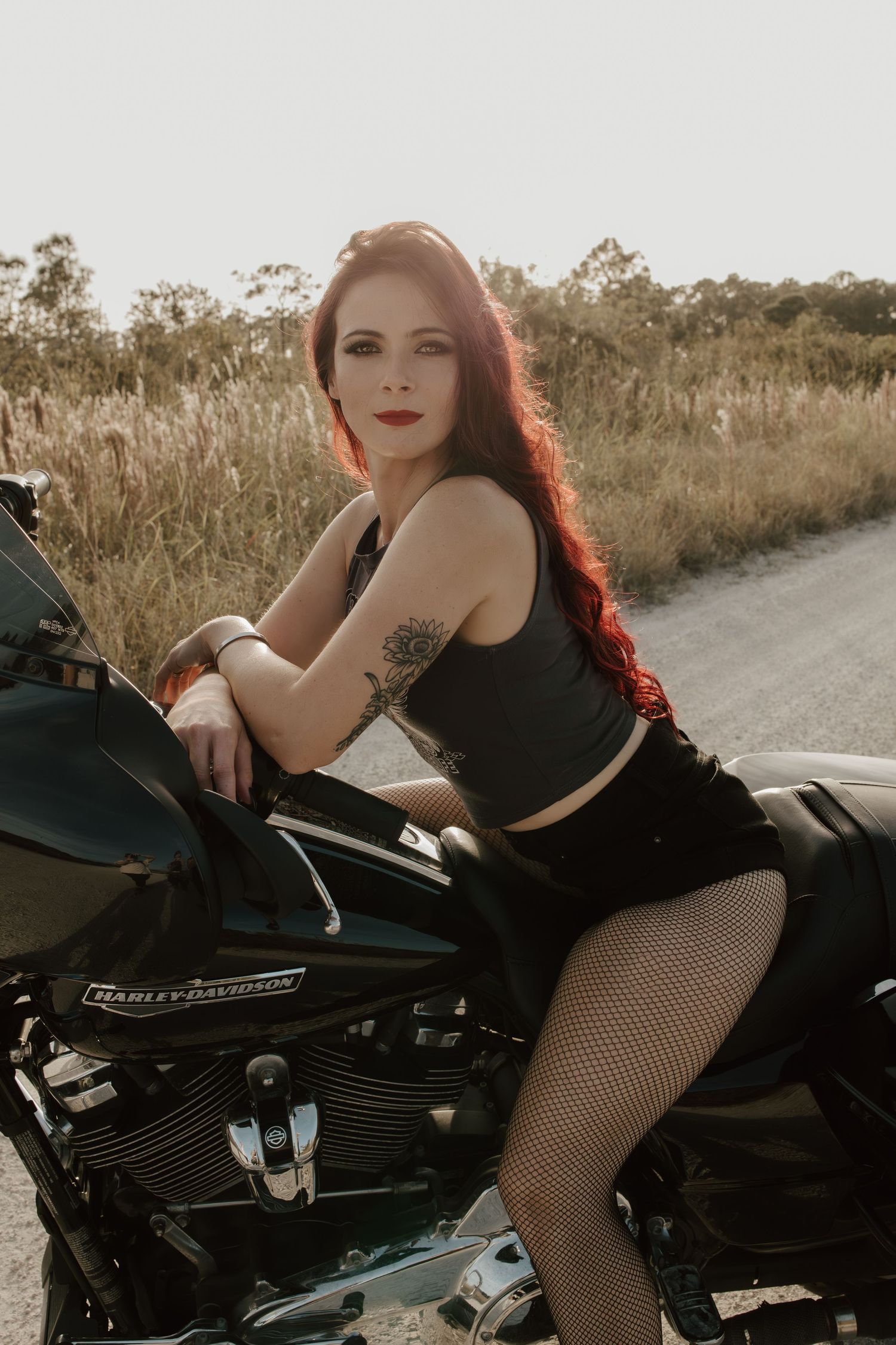 Biker chick posing on motorcycle taken by South Florida Wedding Photographer Lemon and Honey Co.
