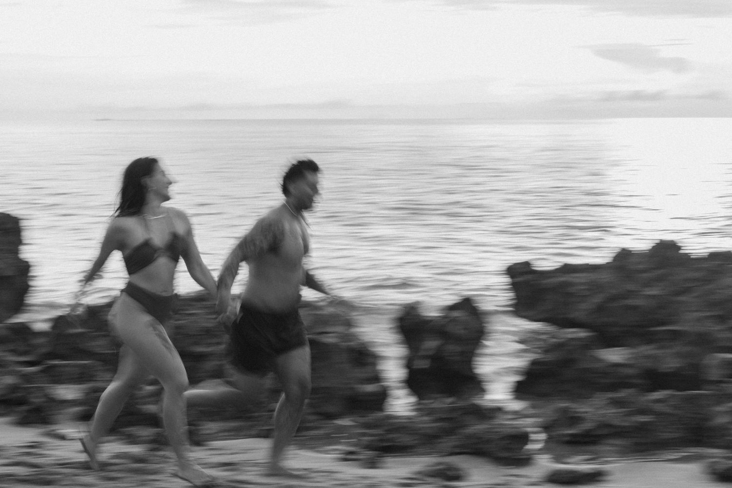 Couple running along the beach taken by South Florida Wedding Photographer Lemon and Honey Co.
