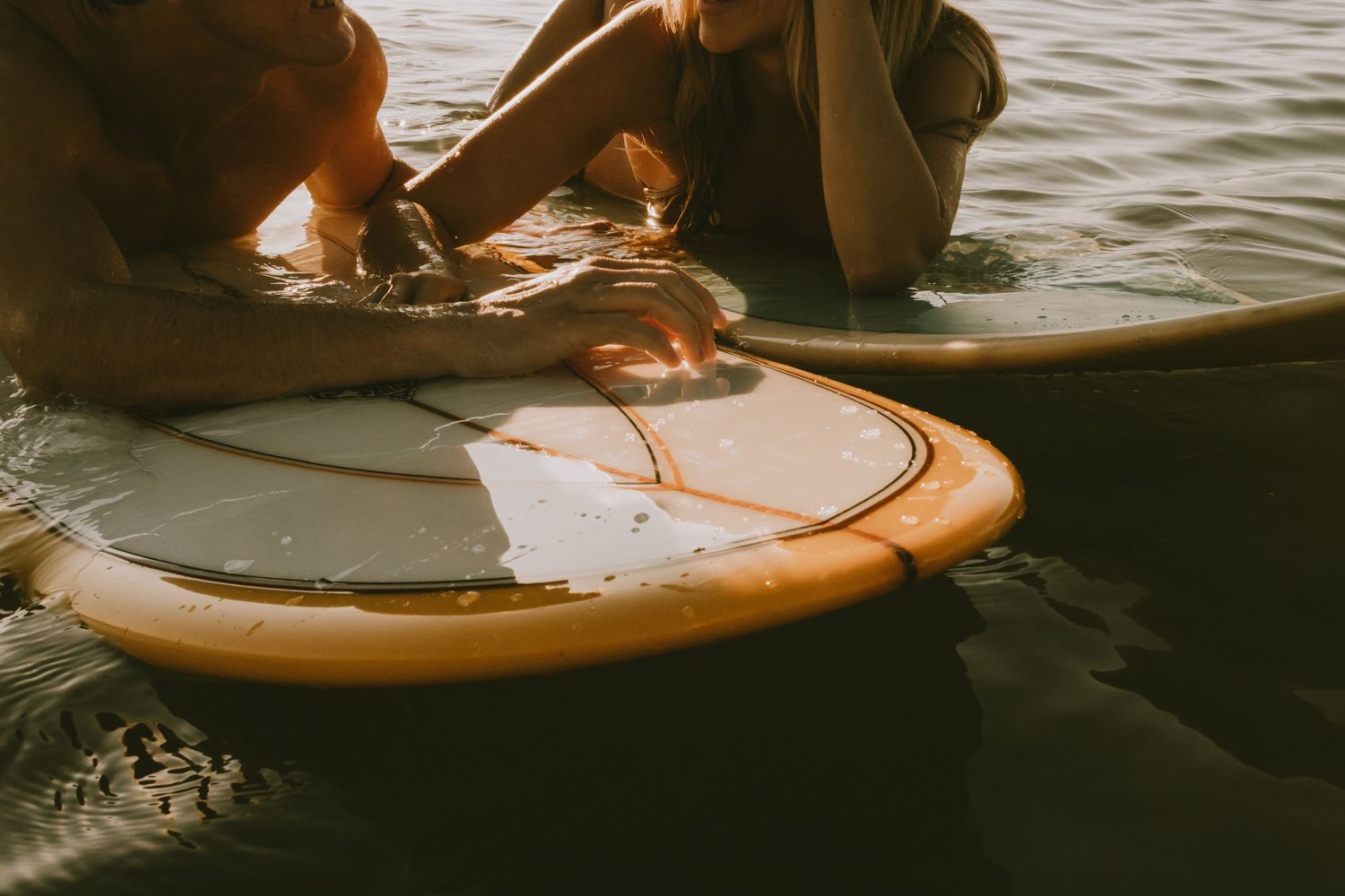 Couple in the water with surfboards taken by South Florida Wedding Photographer Lemon and Honey Co.