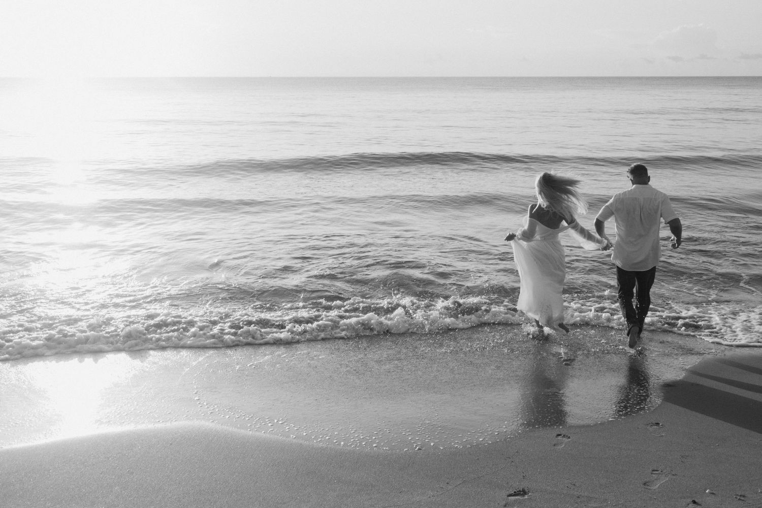 Couple running into the water taken by South Florida Wedding Photographer Lemon and Honey Co.