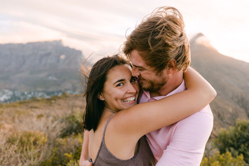 happy couple on signal hill looking at the camera