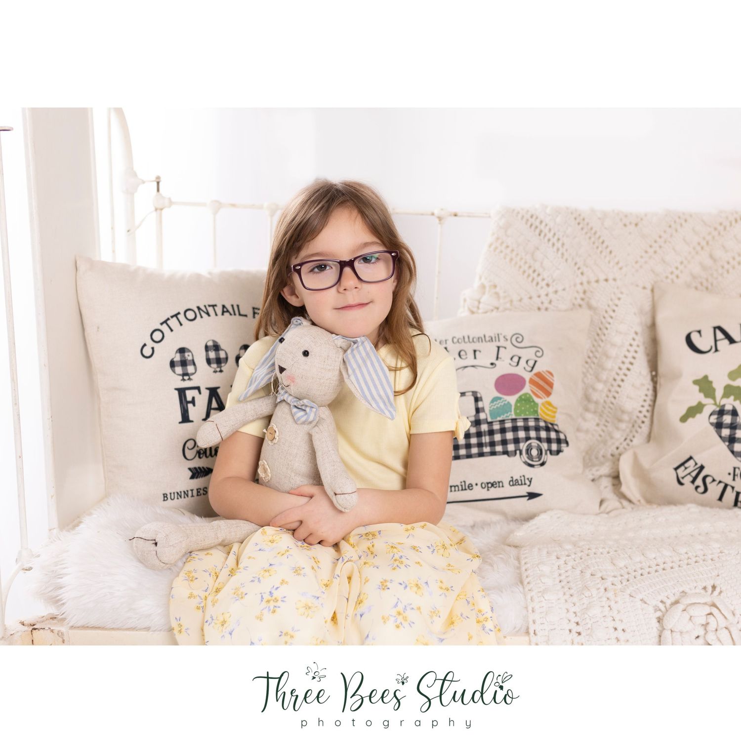 Cozy indoor portrait on white couch with farmhouse style throw pillows.