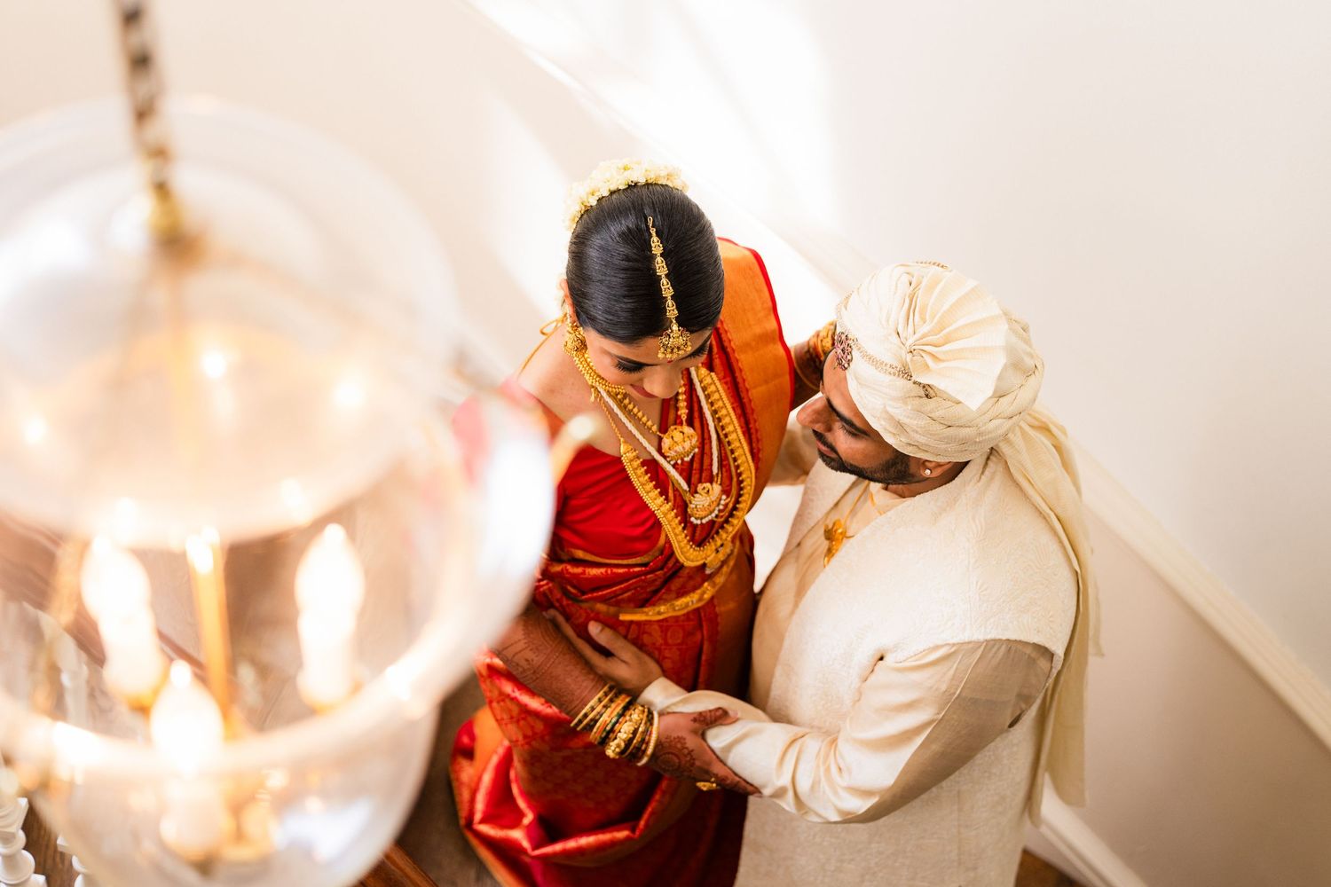 Traditional Indian wedding ceremony with couple in ornate red and white attire.