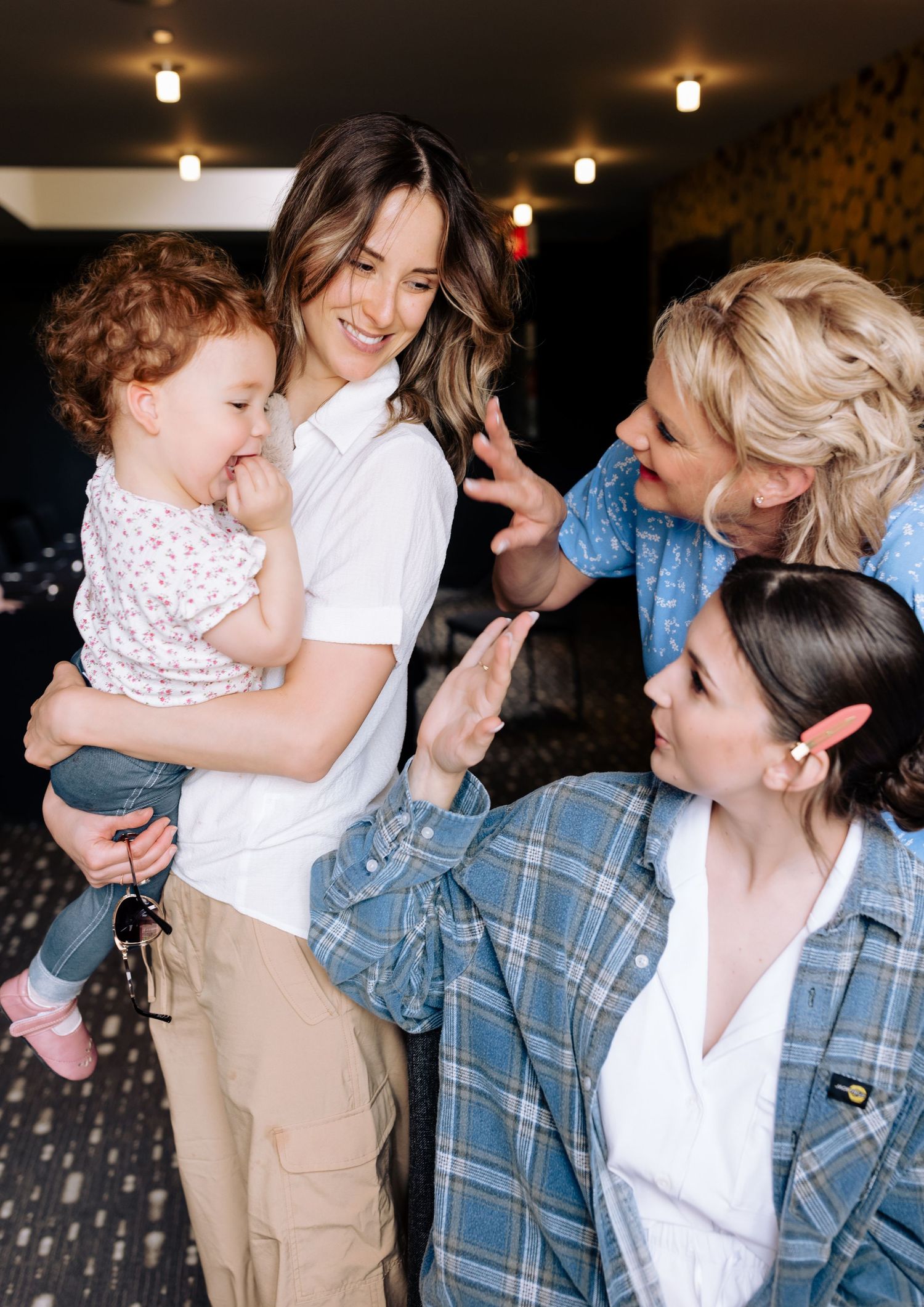 A candid moment showing people sharing laughter and joy indoors.