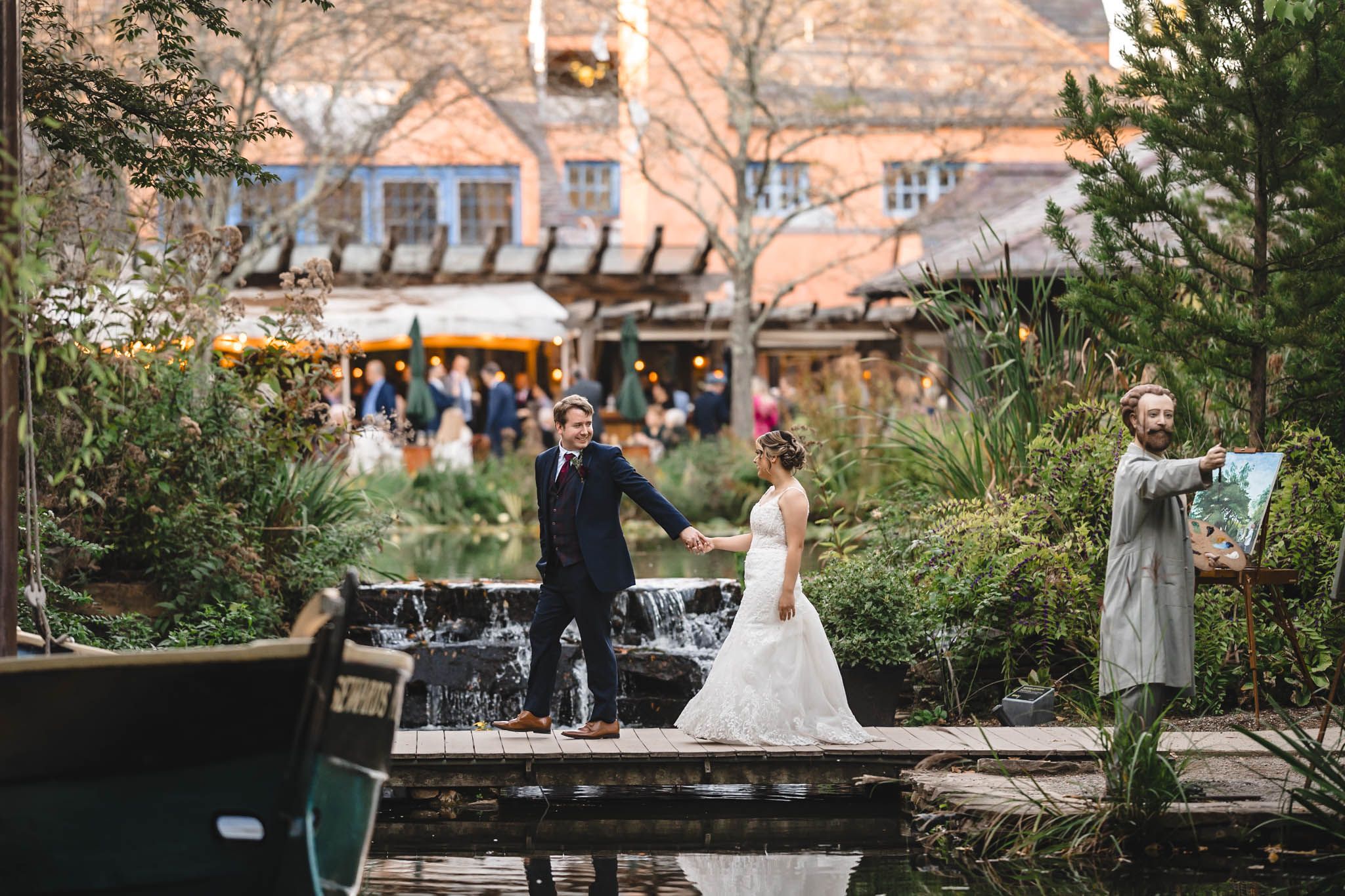 Garden wedding venue with brick walls and lush greenery in late afternoon light.