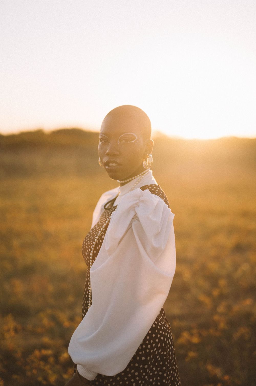 Portrait at golden hour wearing white blouse and leopard print dress.