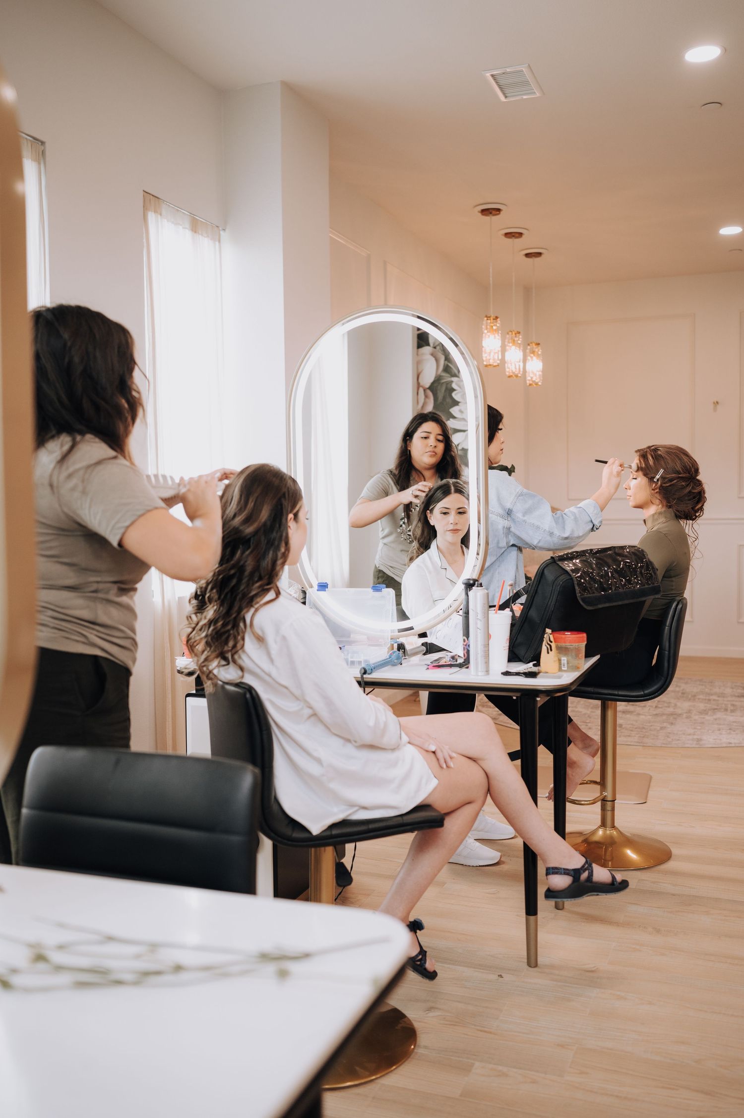 Beauty salon interior with multiple styling stations and mirrors in a bright modern space.