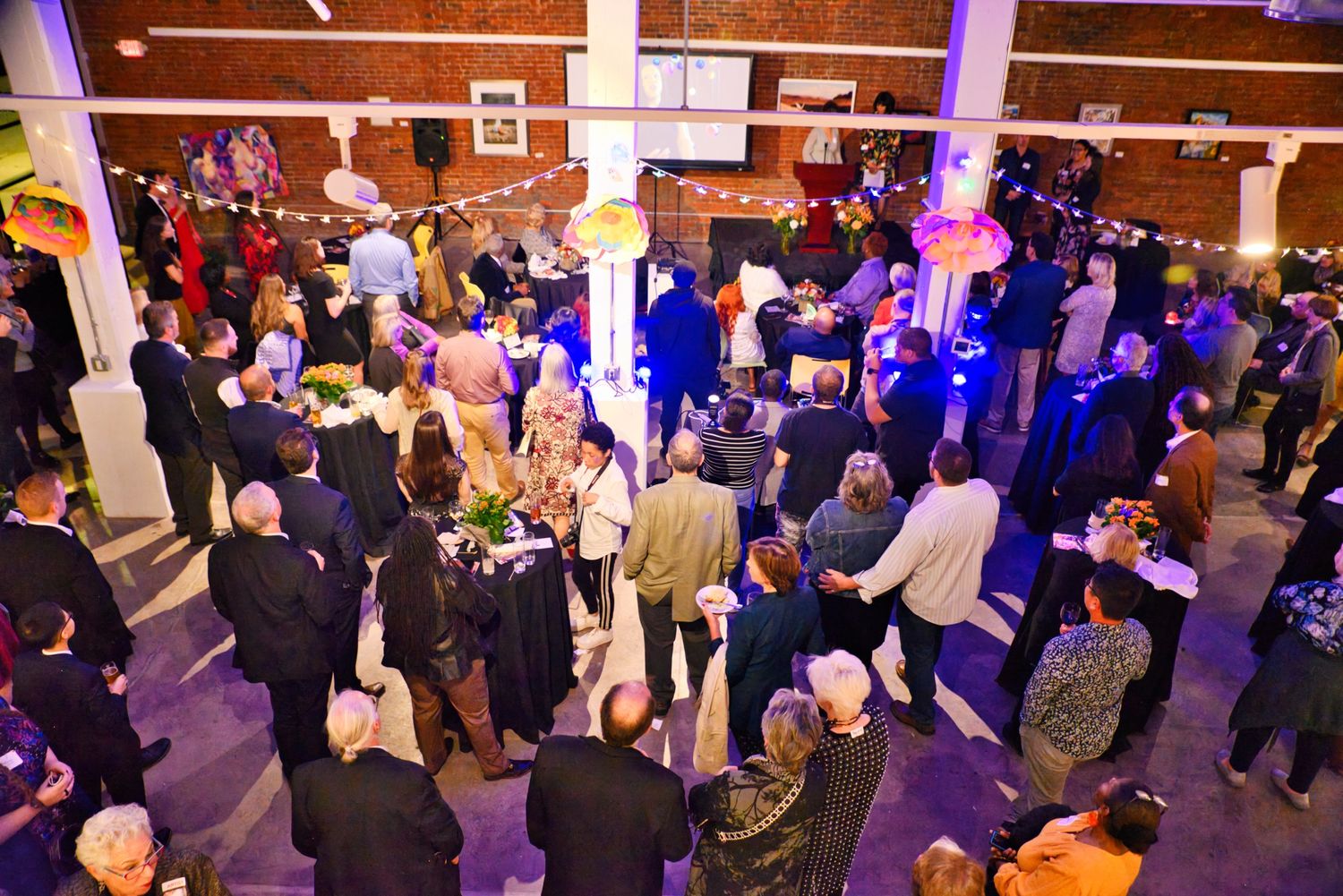 wide angle view of large gathering of people at a party