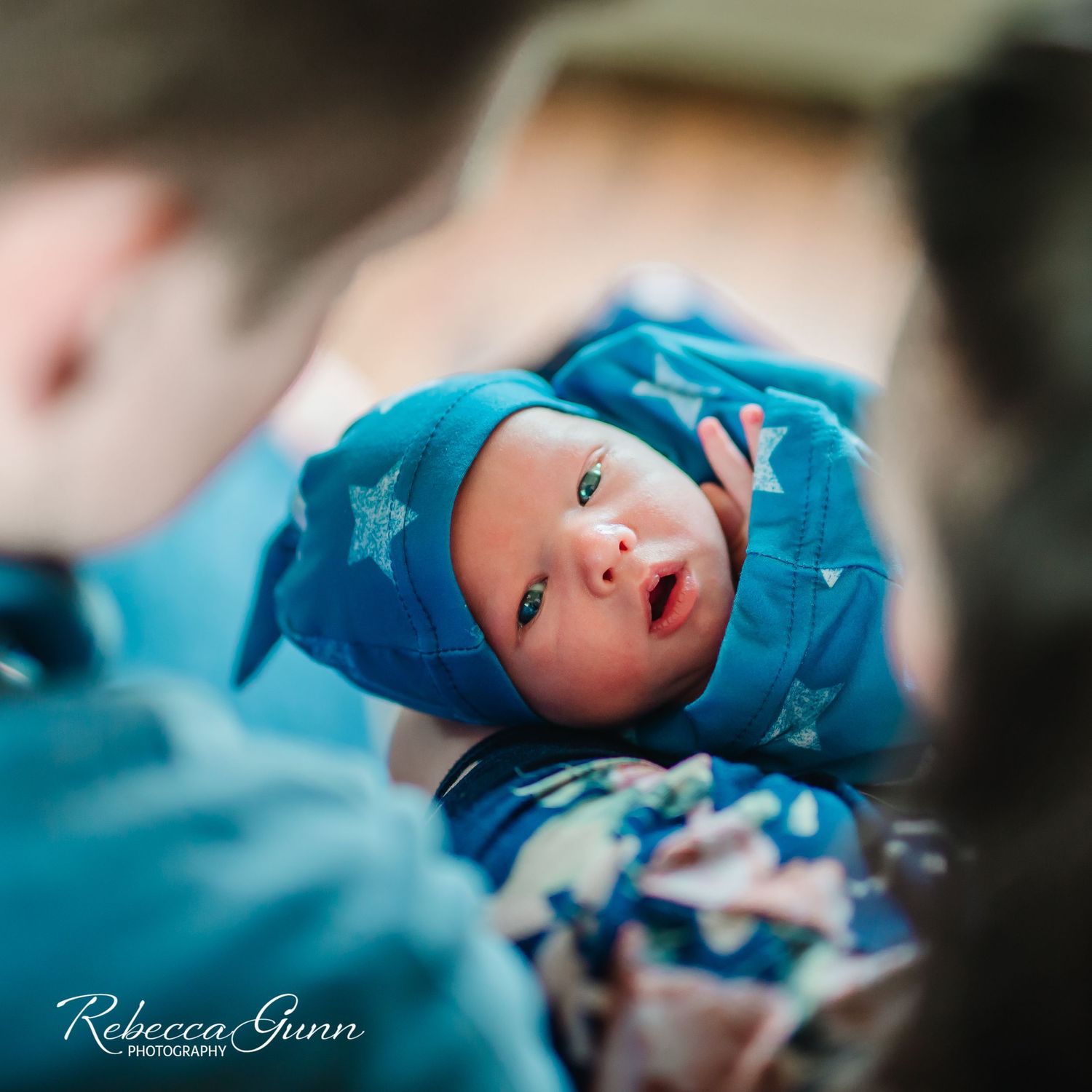 newborn boy with mommy and daddy looking; taken by Tulsa Newborn photographer