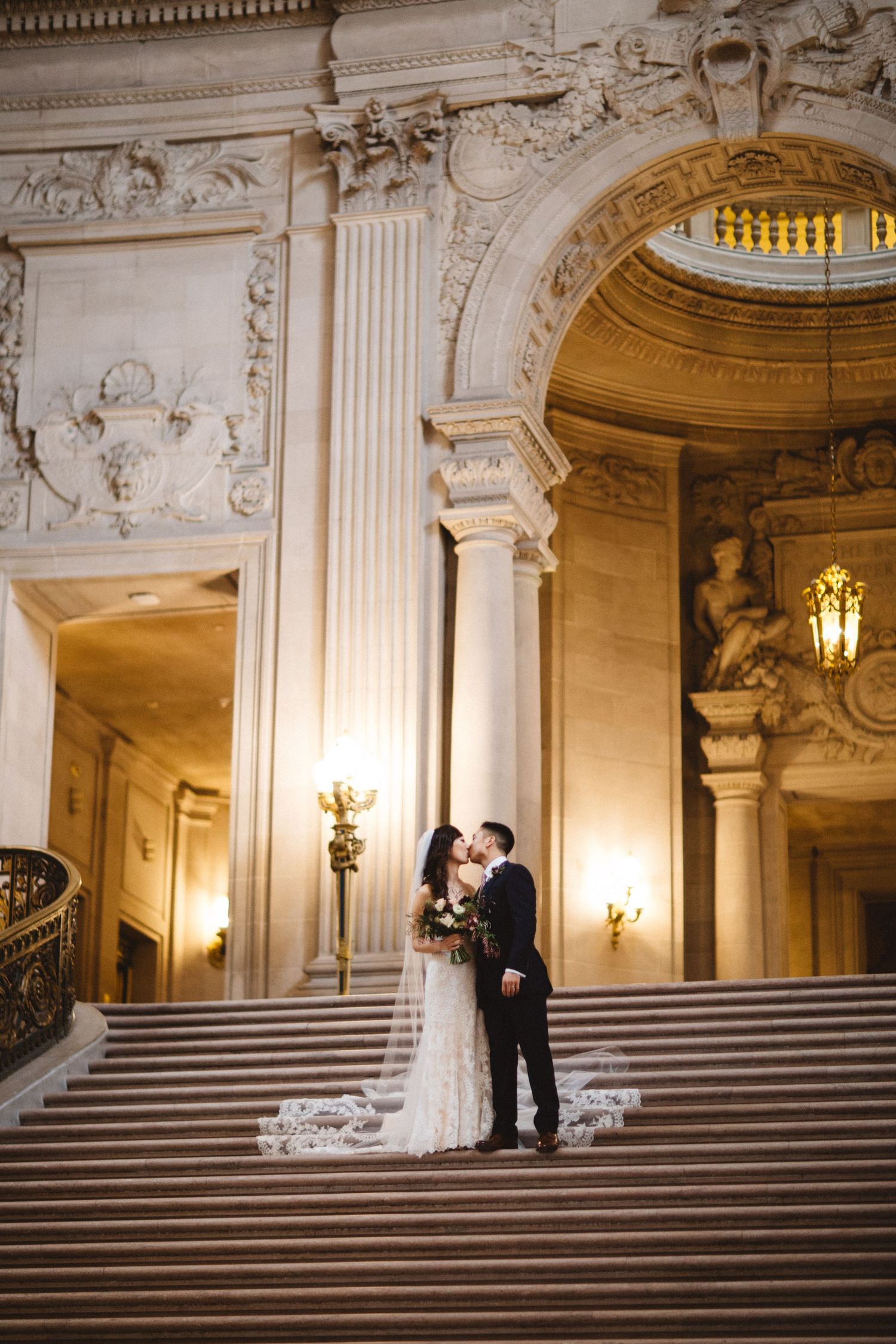 An intimate wedding portrait captured on the iconic steps of San Francisco City Hall.