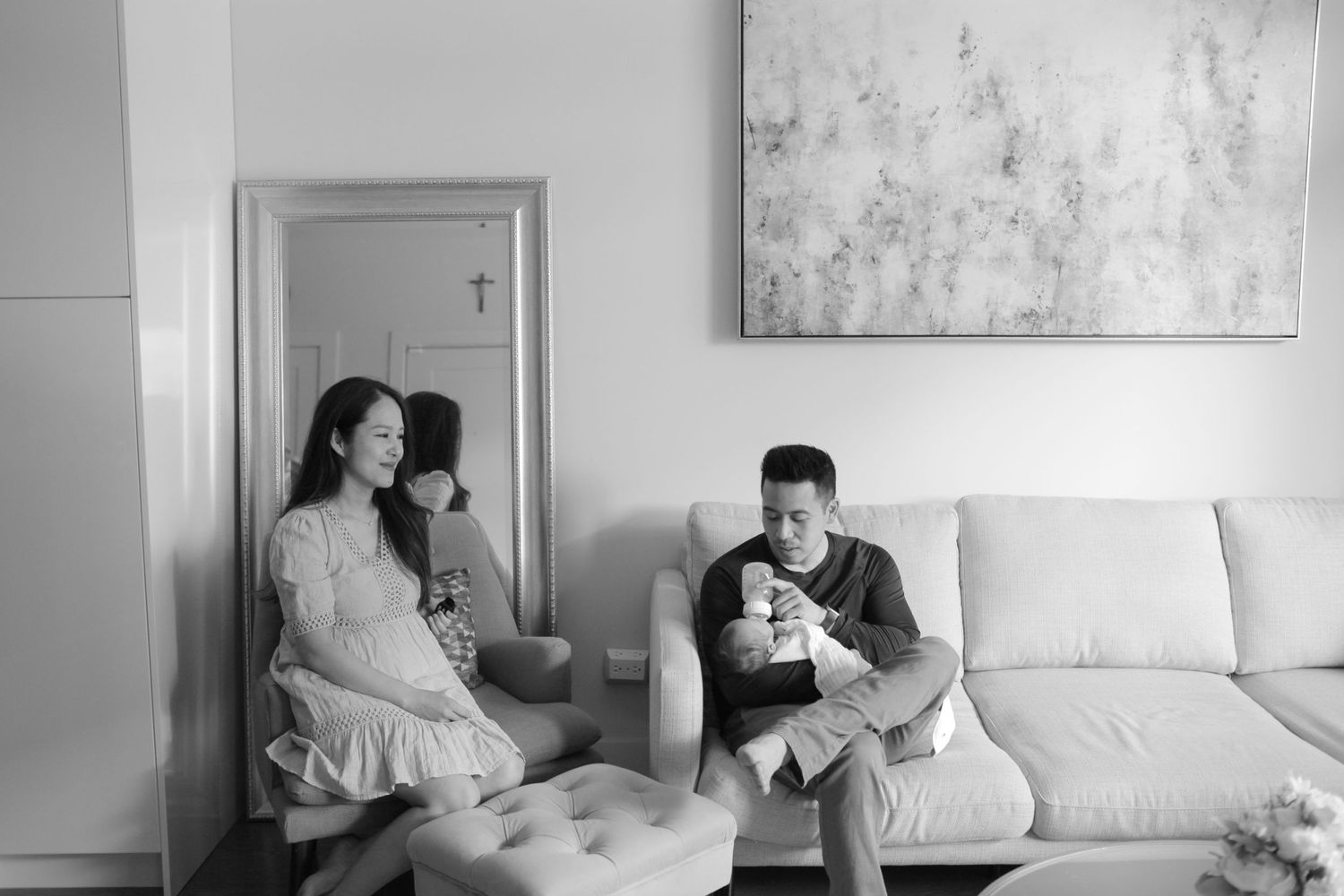 Black and white lifestyle photos showing intimate moments on a white couch.