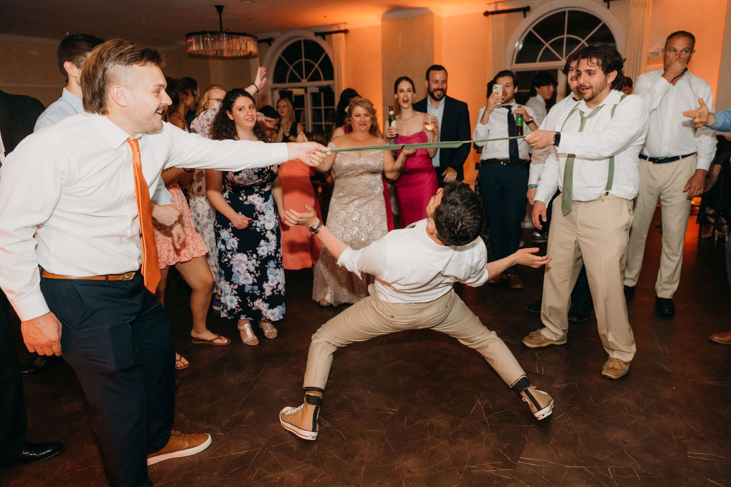 Energetic dance moves captured during a lively wedding reception party.